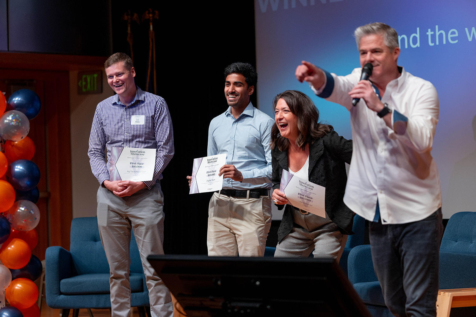 Four people on stage being recognized