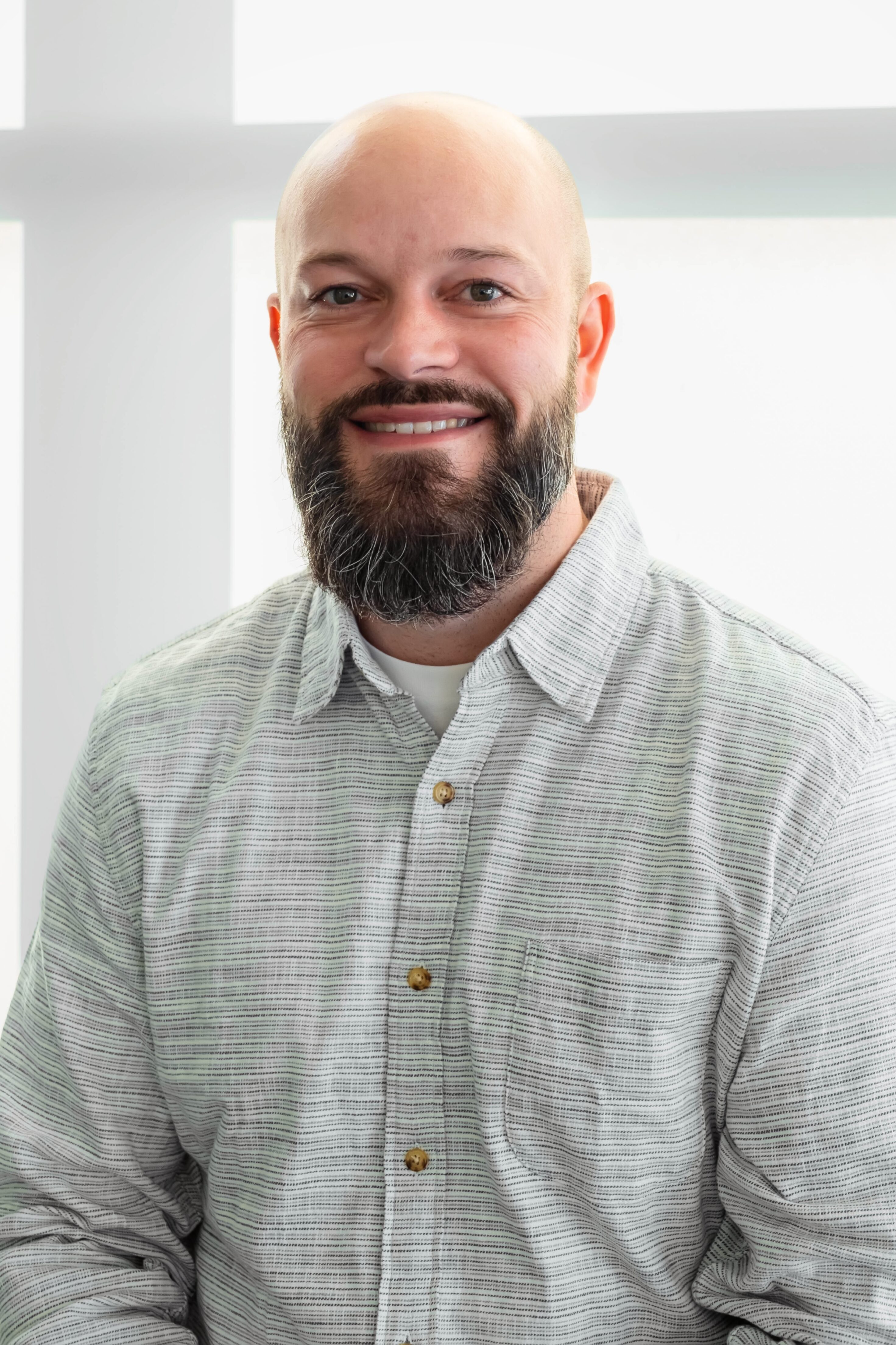 JP Beckley, Brand Designer at Innovatemap, smiling confidently in a professional setting.